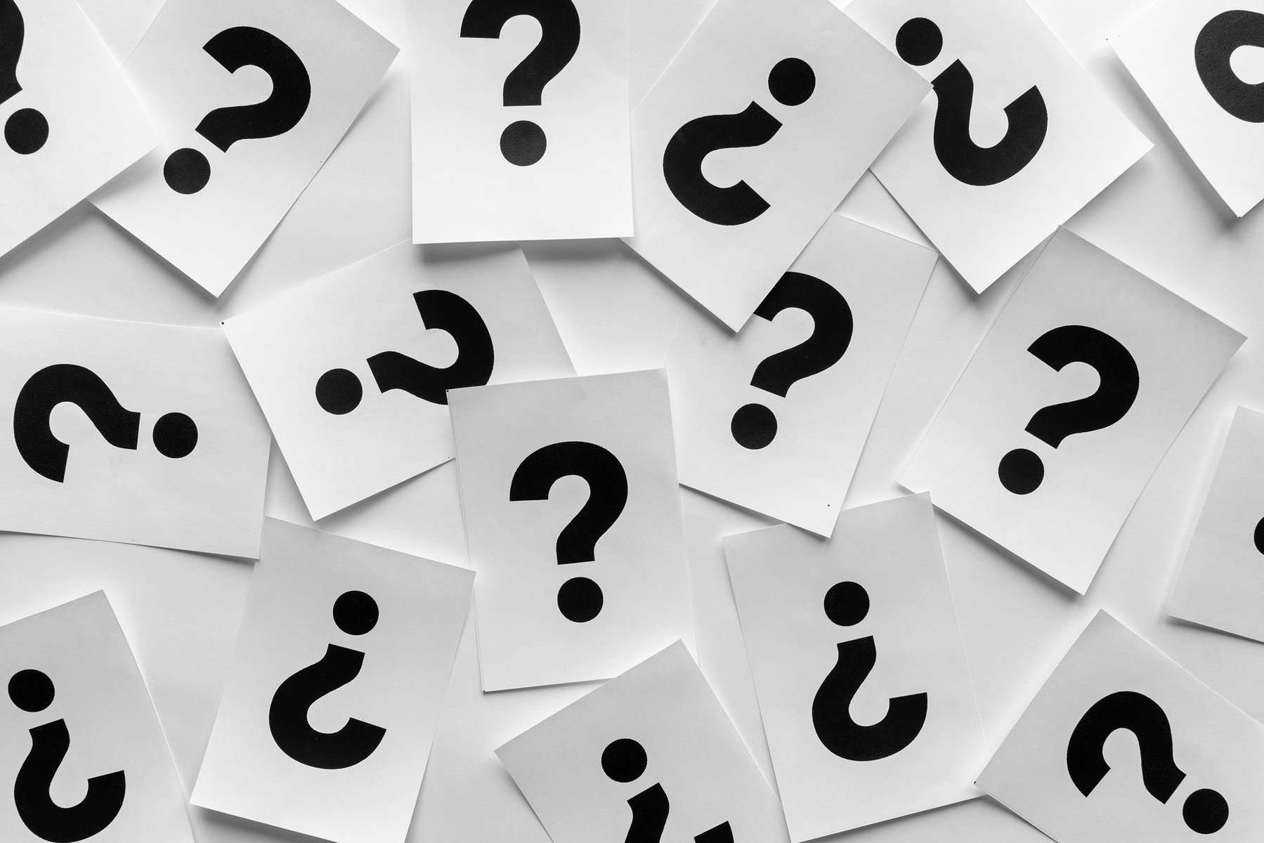 Bold black question marks on paper cards