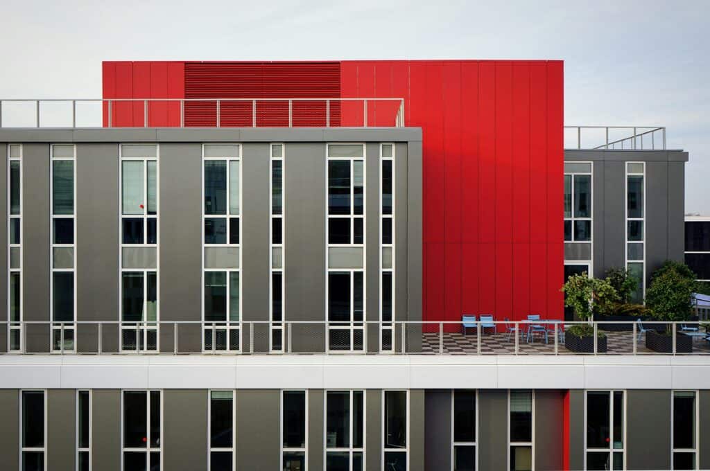 gray and red modern building where companies do sales training