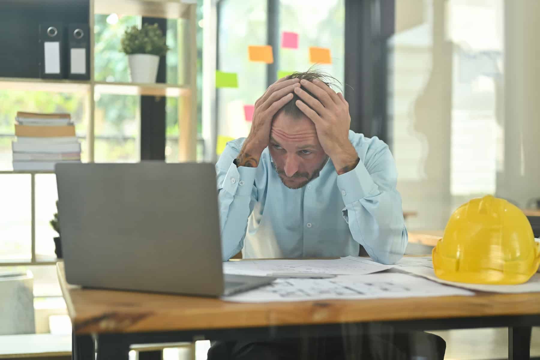 worried man desk construction