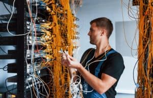 room full of yellow white wires guy plugging them in