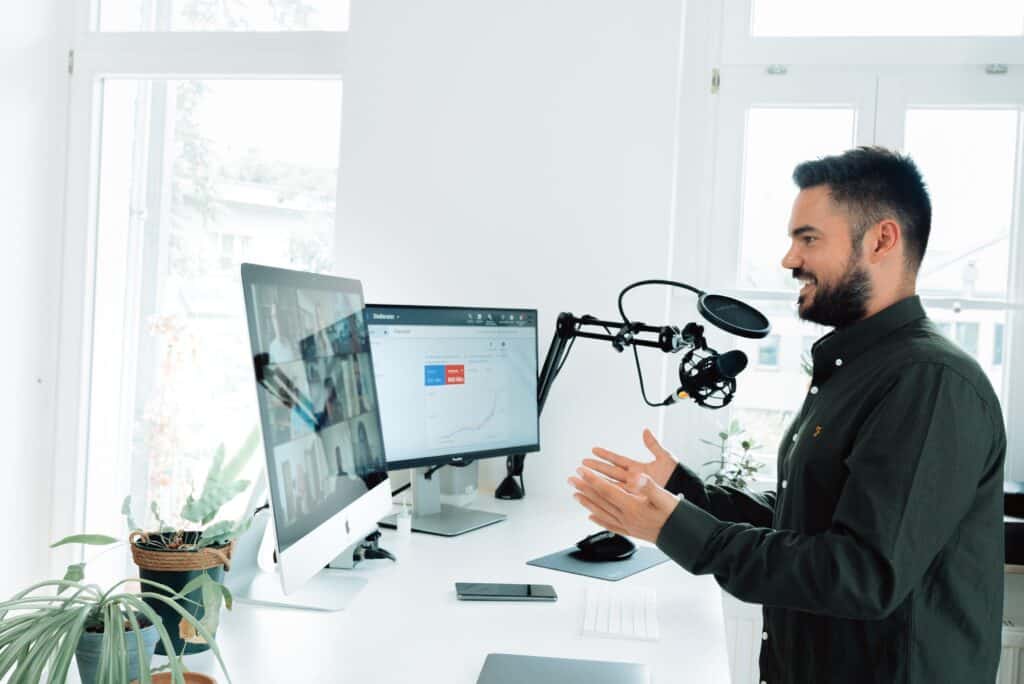 Man at standing desk on a zoom call attempting to close more sales