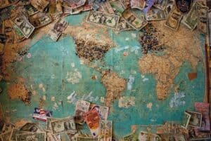 world map with location pins and various currencies