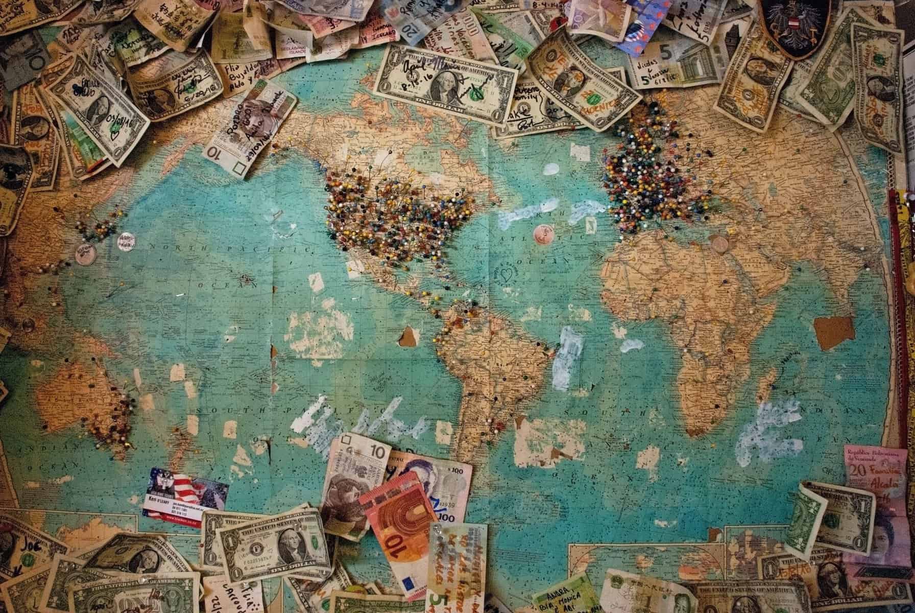 world map with location pins and various currencies