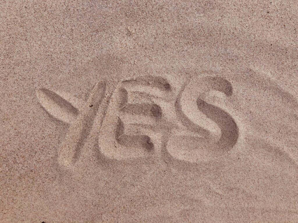 brown sand with yes written in capital letters