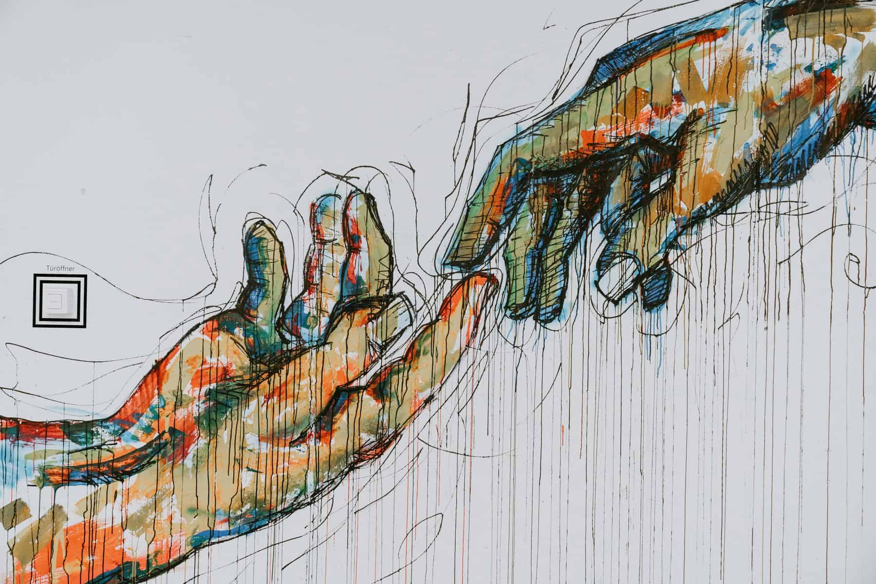 graphic design of two hands reaching to touch each other