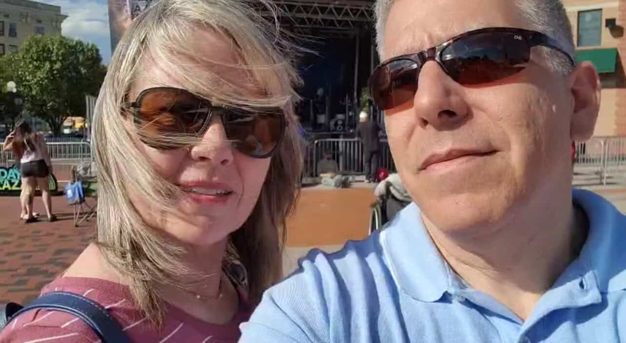 Couple at a concert with stage in background