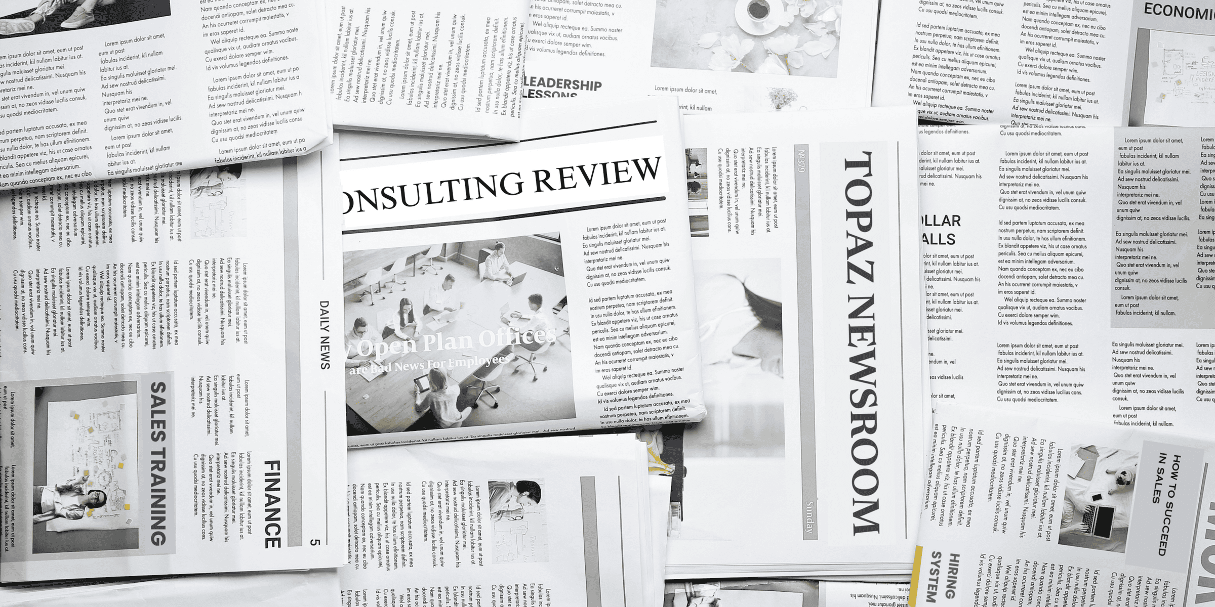 newspapers strewn about with headlines reading consulting review, topaz newsroom, hiring system, sales training