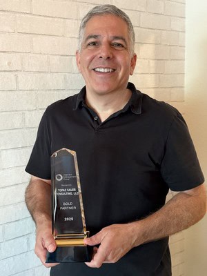 man in black shirt smiling holding an award from Objective Management Group